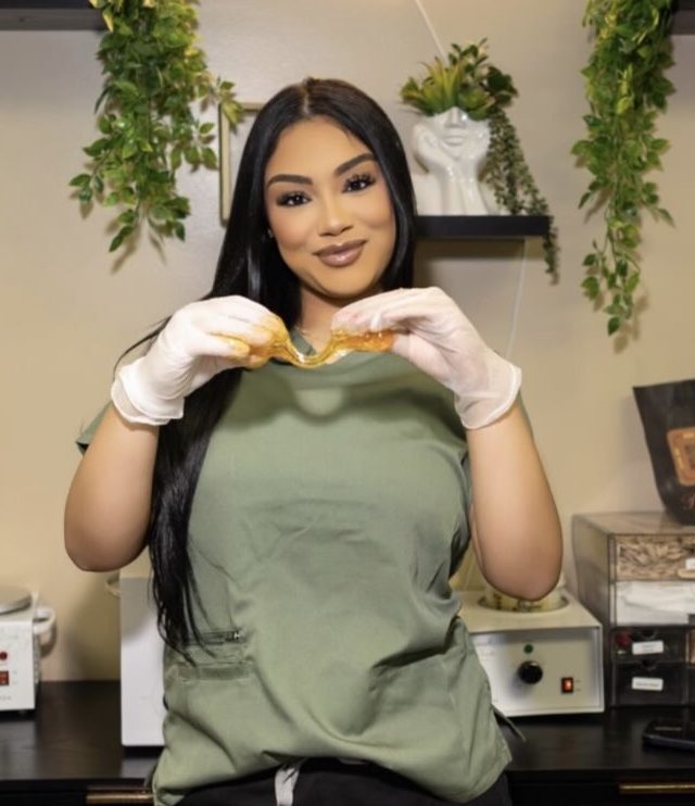 India holding a strip of sugar paste in the Soleil Beauty Bar treatment room